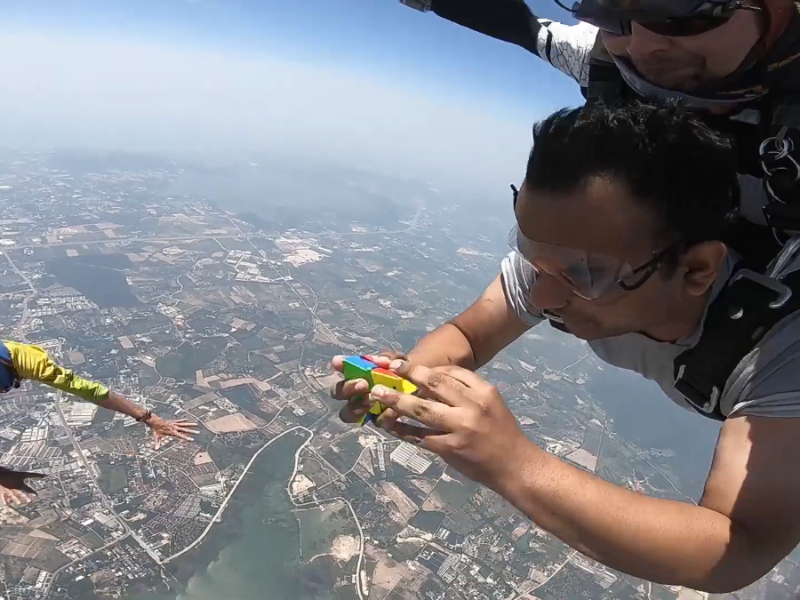 Skydiving Indian man attempts record for fastest time to solve a rotating puzzle tetrahedron whilst in freefall