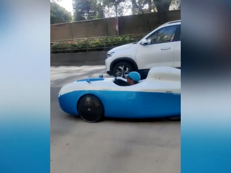 Man rides on road with unique vehicle in southern India