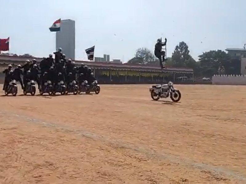 Armyman stands on ladder while riding bike, bikers in pyramid formation follow during 74th Republic Day celebrations in southern India 
