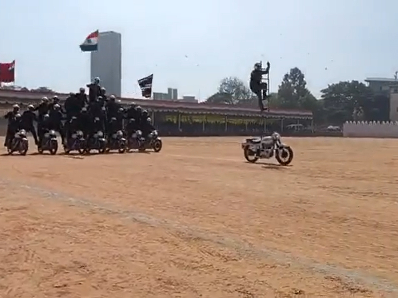 Armyman stands on ladder while riding bike, bikers in pyramid formation follow during 74th Republic Day celebrations in southern India