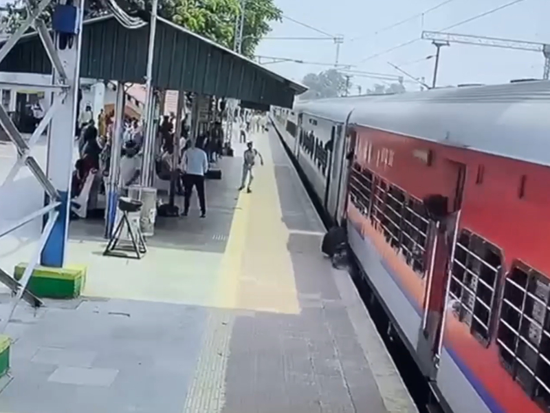 Chilling moment man gets dragged by moving train after he slips while trying to board it in eastern India