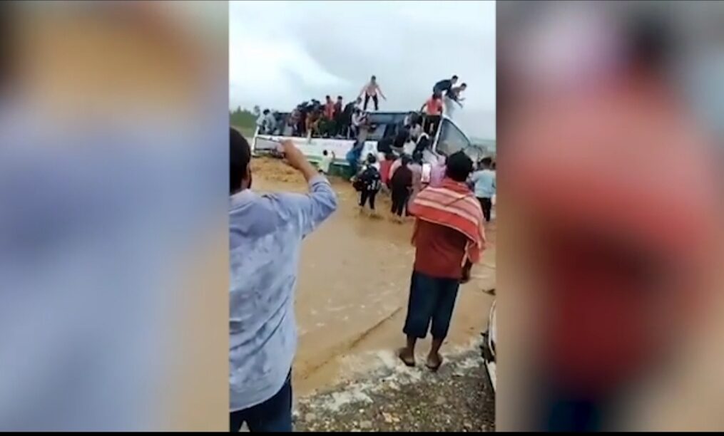 Bus gets stuck in flood in northern India, passengers sneak out of windows