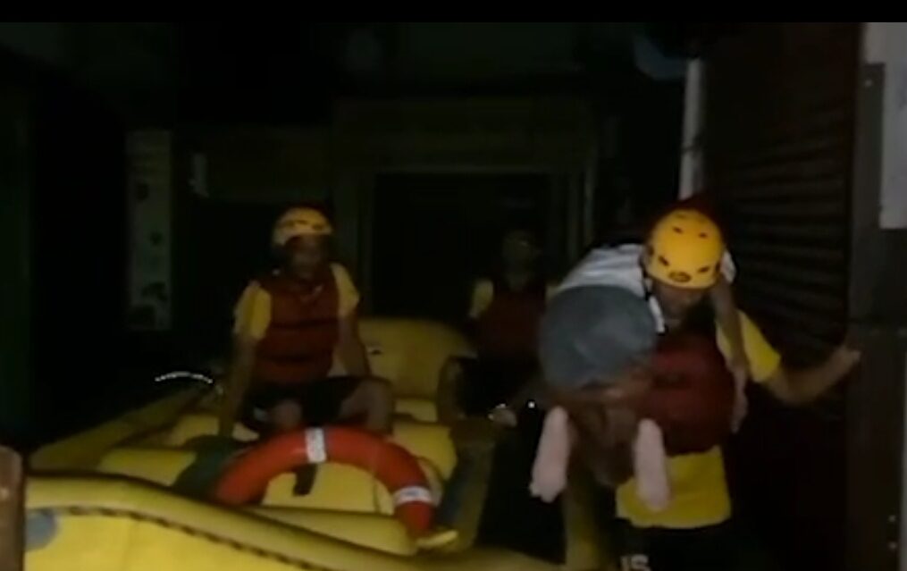 Rescue officials come to the aid of handicapped man trapped in waterlogged house in northern India