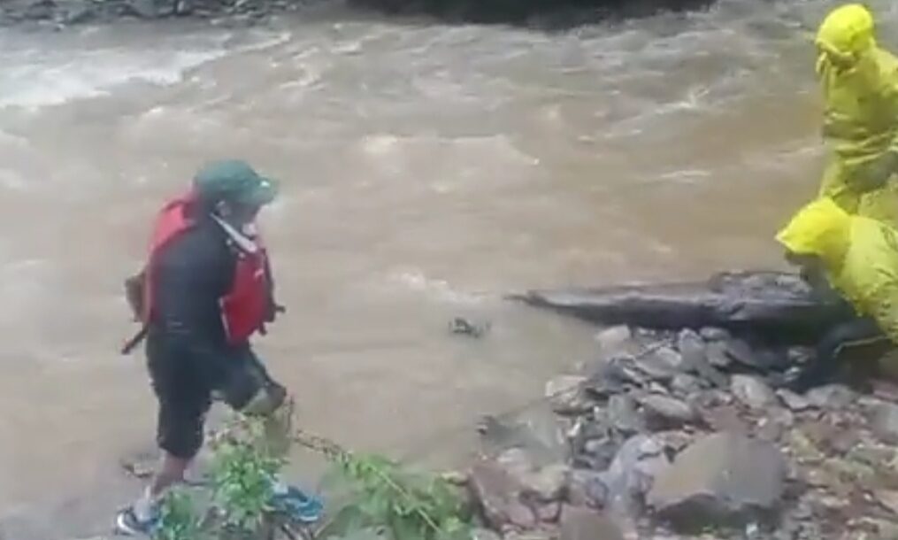 Rescue officials come to the aid of man trapped in river in northern India
