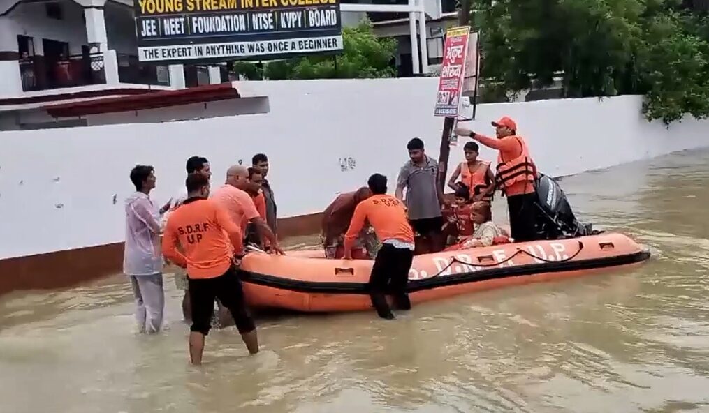 Fire officials come to rescue of people trapped in flooded houses in northern India