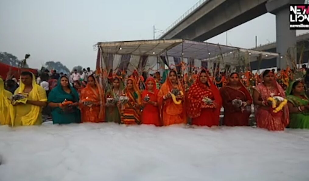 Devotees offer prayers to the sun while standing in knee-deep foam in northern India