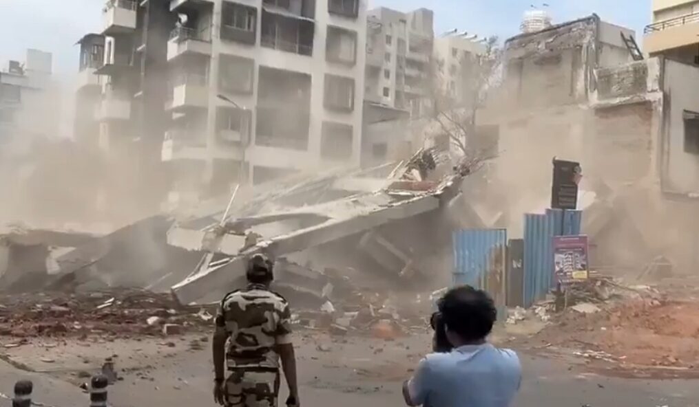Three-storied building under construction tilted in western India; Citizens run