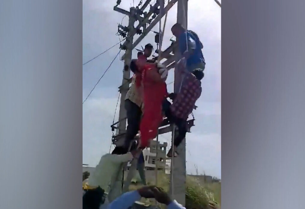 Woman climbs on top of electricity pole after husband refuses to keep her lover inside their house in northern India