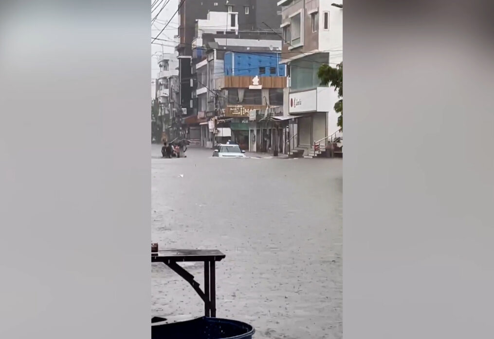 City submerged under torrential downpour as roads morph into rivers with vehicles navigating treacherous waters