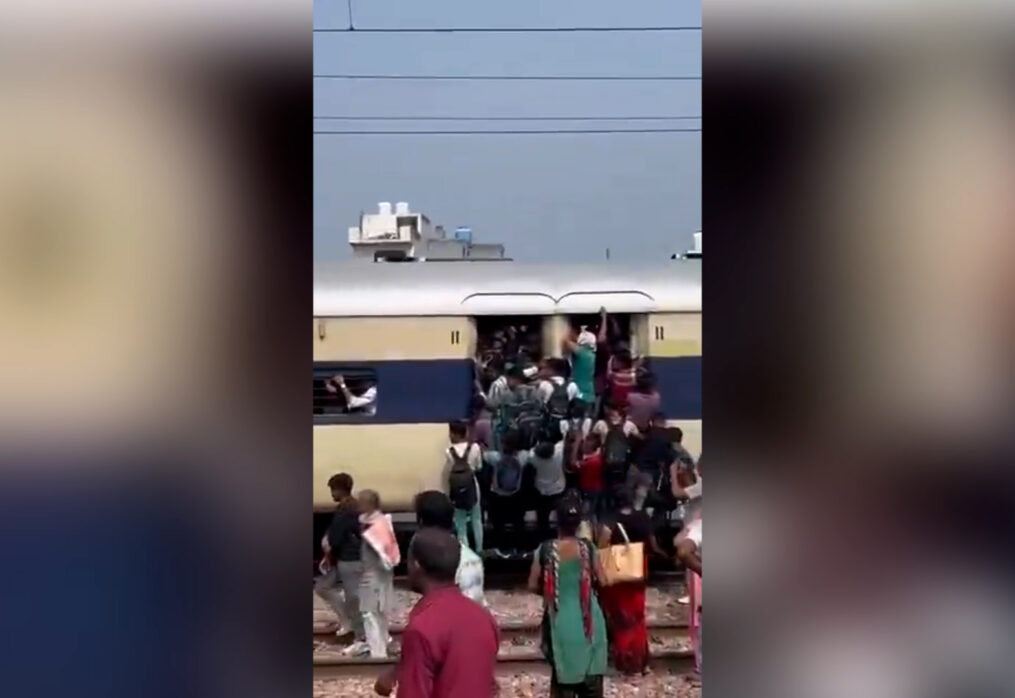 Heart-stopping scenes as commuters cling to train doors while journeying through packed railway tracks